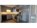 This kitchen features stainless steel appliances, granite countertops and gray wood cabinetry at 501 Carlton Rd # 3F, Palmetto, GA 30268