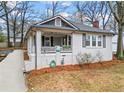 Charming bungalow featuring a covered front porch, painted brick facade, and well-maintained landscaping at 942 Byron Sw Dr, Atlanta, GA 30310
