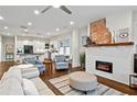 Open-concept living room featuring a fireplace, hardwood floors, and natural light at 942 Byron Sw Dr, Atlanta, GA 30310