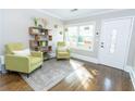 Stylish entryway featuring hardwood floors, a bookshelf, and modern decor with lots of natural light at 988 Farrington Se Pl, Atlanta, GA 30315