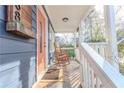 Inviting covered front porch with rocking chairs, perfect for enjoying the outdoors at 988 Farrington Se Pl, Atlanta, GA 30315