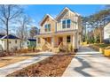 Beautiful two-story home with a charming front porch, a well-maintained yard, and a long driveway at 1106A Wedgewood Nw Dr, Atlanta, GA 30318