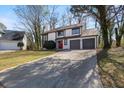 Two-story home with a two-car garage and a long driveway at 1628 Links Overlook, Stone Mountain, GA 30088