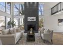 Bright living room with a fireplace, tall windows, and hardwood floors at 1628 Links Overlook, Stone Mountain, GA 30088