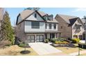 Attractive two-story house featuring a two-car garage, cozy front porch, and beautifully landscaped yard at 4916 Kentwood Dr, Marietta, GA 30068