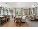 Open-concept living area featuring a modern kitchen, dining space, and a comfortable seating area with natural light at 525 Burlrush Ln # 16, Alpharetta, GA 30009