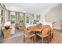 Bright and airy living space with a dining area, comfortable seating, and easy access to outdoor via door at 525 Burlrush Ln # 16, Alpharetta, GA 30009