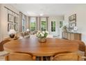 Inviting living room featuring neutral tones, stylish decor, and a large dining table for entertaining at 525 Burlrush Ln # 16, Alpharetta, GA 30009