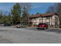 Exterior view of building with well-maintained parking lot and mature trees surrounding at 1213 Camelot Dr, Atlanta, GA 30349