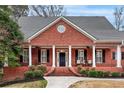 Classic brick facade with white columns accenting the covered front porch and black shutters at 2914 Stanway Ave, Douglasville, GA 30135