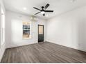 Light-filled bedroom with modern flooring, neutral paint, ceiling fan and exterior door access at 1106B Wedgewood Nw Dr, Atlanta, GA 30318