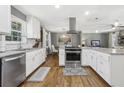 Bright, modern kitchen with white cabinets, stainless steel appliances, and granite countertops at 3597 Embry Cir, Atlanta, GA 30341