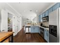 Stylish kitchen with stainless steel appliances, blue cabinets, and hardwood floors at 655 Mead Se St # 7, Atlanta, GA 30312