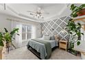 Serene bedroom with tray ceiling, decorative wall, and ample natural light at 655 Mead Se St # 7, Atlanta, GA 30312