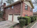 A lovely two-story brick home, featuring a two-car garage and well-maintained landscaping at 951 Bingham Ln, Stone Mountain, GA 30083