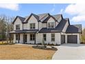 Charming home with a neatly landscaped lawn, a two-car garage, and a paved driveway at 1629 Phillips Rd, Lithonia, GA 30058