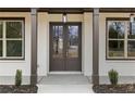 Close-up of the front entrance with double doors, large windows, and decorative columns at 1629 Phillips Rd, Lithonia, GA 30058