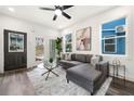 Bright living room with gray sectional sofa, glass coffee table, ceiling fan, and stylish decor at 2668 Brown Nw St, Atlanta, GA 30318
