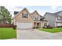 Traditional two-story home with a two-car garage and a neatly landscaped front yard, exuding curb appeal at 3248 Meadow Point Dr, Snellville, GA 30039