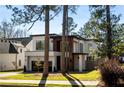 Contemporary home featuring a modern design, large windows, and professional landscaping at 1051 Wimberly Ne Rd, Brookhaven, GA 30319