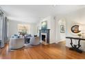 Bright living room with hardwood floors, fireplace, elegant furniture, and an archway that leads to other spaces at 1605 E Sussex Ne Rd, Atlanta, GA 30306