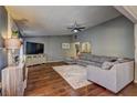 Inviting living room showcasing hardwood floors, a comfortable sofa, and an entertainment center at 3085 Nappa Trl, Stone Mountain, GA 30087