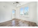 Bright bedroom with modern lighting, wood floors, and a balcony for natural light at 525 Parkway Ne Dr # 314, Atlanta, GA 30354