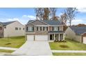 Inviting two-story home with a brick facade, three-car garage and well-manicured lawn at 5436 Flat Rock Point Pt, Stonecrest, GA 30038