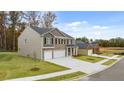 Charming two-story home with a brick and siding exterior, three-car garage and green lawn at 5436 Flat Rock Point Pt, Stonecrest, GA 30038