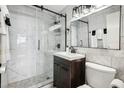 Modern bathroom with sleek vanity, marble walls, and glass shower doors at 215 Piedmont Ne Ave # 1804, Atlanta, GA 30308