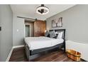 Cozy bedroom with a modern bed frame, wood-style floors, and a rustic sliding barn door at 215 Piedmont Ne Ave # 1804, Atlanta, GA 30308