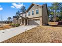 Beautiful two-story home with a two-car garage and green space, perfect for outdoor living at 3596 Maple Hill Rd, Lithonia, GA 30038