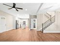 Open-concept living room showcasing modern hardwood flooring, staircase, and a kitchen area at 200 Adeline Nw Ave, Atlanta, GA 30314