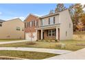 Inviting two-story home with brick and siding accents, a well-manicured lawn, and a charming entryway at 5441 Flat Rock Point Pt, Stonecrest, GA 30038