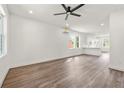 Bright living room featuring modern ceiling fan, recessed lighting, wood floors, and mini split a/c at 2680 Brown Nw St, Atlanta, GA 30318