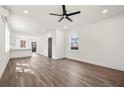 Bright and airy living room showcasing wood flooring, a ceiling fan, and a door to the outside at 2680 Brown Nw St, Atlanta, GA 30318