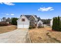 Beautiful two-story home with a two-car garage and well-maintained lawn on a sunny day at 2738 Lakewater Way, Snellville, GA 30039