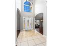 Welcoming foyer with tile flooring, arched doorways, and a chandelier at 2738 Lakewater Way, Snellville, GA 30039