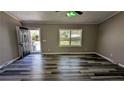 Spacious living room featuring stylish wood-look floors, neutral paint, a front door, and ample natural light at 4195 Bradley Dr, Snellville, GA 30039