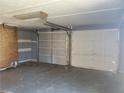 Two-car garage with brick wall, two garage doors and storage space at 455 Sweet Water Trl, Conyers, GA 30094