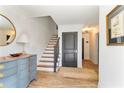 Bright foyer showcasing wood floors, staircase, and decorative furnishings at 5705 Odell St, Cumming, GA 30040