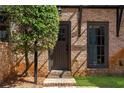 Inviting entryway featuring a brick facade, manicured lawn and an arched front door at 5705 Odell St, Cumming, GA 30040