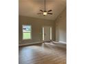 Bright entryway with white door, neutral walls, ceiling fan, and hardwood floors at 8141 Hickory Dr, Covington, GA 30014