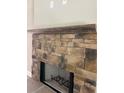 Close up of the detailed stone fireplace with a hearth and raw wood mantle at 8141 Hickory Dr, Covington, GA 30014