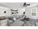 Bright living room featuring a comfortable gray sectional sofa and modern ceiling fan at 1501 Mcgill Park Ne Ave # 1501, Atlanta, GA 30312