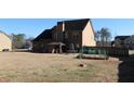 Spacious backyard featuring a patio, gardening area, and lush greenery, ideal for outdoor entertaining and relaxation at 40 Adler Pl, Covington, GA 30016