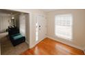 Bright entryway featuring hardwood floors, a white front door, and a large window for natural light at 4995 Greentree Trl, College Park, GA 30349