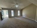 Bright living room featuring neutral paint and plush carpeting at 5872 Fox Run, Rex, GA 30273