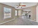 Cozy living room featuring neutral paint, plush carpet, and bright windows for ample natural light at 81 Sheffield Ln, Powder Springs, GA 30127