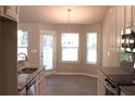 Well-equipped kitchen with stainless steel appliances, granite countertops, and wood flooring at 84 Jennifer Ln, Covington, GA 30016